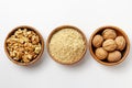 Whole walnuts, walnut kernel and ground walnuts in wooden bowls Royalty Free Stock Photo