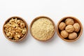 Whole walnuts, walnut kernel and ground walnuts in wooden bowls