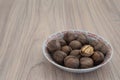 Whole walnuts and walnut kernels on wooden table