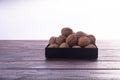 Whole walnuts on wooden table, side view on white background. Healthy nuts and seeds composition. Royalty Free Stock Photo