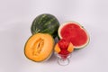 Whole watermelon cantaloup and watermelon halves cup of melon fruit scoops Royalty Free Stock Photo