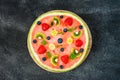 Whole watermelon pizza with fruits, dark background, top view Royalty Free Stock Photo