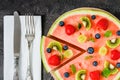 Whole watermelon pizza sliced with fruits, dark background, top view Royalty Free Stock Photo