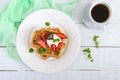 Whole wheat Belgian waffles with whipped cream, freshly chopped strawberries, mint leaves and chocolate Royalty Free Stock Photo