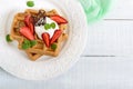 Whole wheat Belgian waffles with whipped cream, freshly chopped strawberries Royalty Free Stock Photo