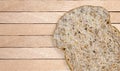 Whole wheat bread cut into pieces on a wooden plate  background Royalty Free Stock Photo