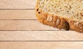 Whole wheat bread cut into pieces on a wooden plate  background Royalty Free Stock Photo