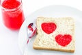 Whole wheat bread with heart shape of strawberry jam in white pl Royalty Free Stock Photo