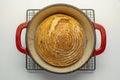 Whole wheat bread loaf baked in dutch oven iron cast pot, pure levain Royalty Free Stock Photo