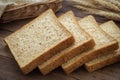 Whole wheat bread slices and wheat on wooden table Royalty Free Stock Photo