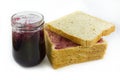 Whole wheat bread stack with grape jam on isolated white background. Royalty Free Stock Photo
