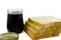 Whole wheat bread stack with grape jam on isolated white background. Royalty Free Stock Photo