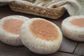 Whole wheat english muffins on wooden table