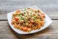 Whole wheat fusilli pasta with cheese and cherry tomatoes Royalty Free Stock Photo