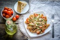 Whole wheat fusilli pasta with cheese and cherry tomatoes Royalty Free Stock Photo