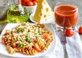 Whole wheat fusilli pasta with cheese and cherry tomatoes Royalty Free Stock Photo