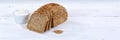 Whole wheat grain bread slice slices sliced loaf banner copyspace on wooden board Royalty Free Stock Photo