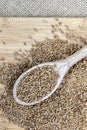 Whole wheat grains in a wooden spoon on a wooden table Royalty Free Stock Photo