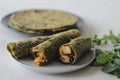 Whole wheat methi thepla rolls with paneer capsicum filling and a bowl of masala curd
