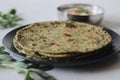 Whole wheat methi thepla rolls with paneer capsicum filling and a bowl of masala curd