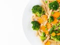 Whole wheat pasta Penne with broccoli, carrots, green peas. Part of plate, copy space. Diet menu, proper nutrition, healthy food Royalty Free Stock Photo