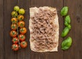 Whole wheat pasta, tomatoes and basil Royalty Free Stock Photo