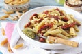 Whole wheat penne pasta with pesto sauce and sun-dried tomatoes and pine nut Royalty Free Stock Photo