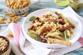 Whole wheat penne pasta with pesto sauce and sun dried tomatoes and pine nut Royalty Free Stock Photo