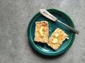 Whole wheat scone with melting butter on plate with knife Royalty Free Stock Photo