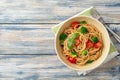 Whole wheat spaghetti pasta with broccoli, cherry tomatoes and basil in bowl on wooden background Royalty Free Stock Photo