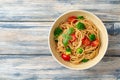 Whole wheat spaghetti pasta with broccoli, cherry tomatoes and basil in bowl on wooden background Royalty Free Stock Photo