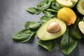 Whole yellow lemons, Apple halves, avocado with a stone, whole yellow lemons, green ripe spinach leaves, a blank sheet of