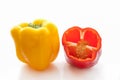 Whole yellow and red half cut fresh bell peppers Royalty Free Stock Photo