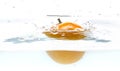 Yellow tomato fall in water. Photo in action. Drops of water. Isolated white background