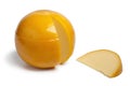 Whole yellow round Edam cheese with a slice