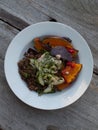 Wholefoods pumpkin and quinoa dish on wooden table