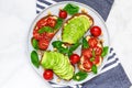 Wholegrain bread avocado and tomatoes toasts with hummus, sesame and basil in a plate with towel Royalty Free Stock Photo