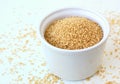 Wholegrain couscous in the bowl on the white background