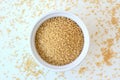 Wholegrain couscous in the bowl on the white background