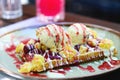 Wholegrain flour crusty belgian waffle with a scoop of ice cream and toppings. Belgian waffle with vanilla ice cream, strawberry Royalty Free Stock Photo