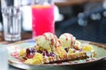 Wholegrain flour crusty belgian waffle with a scoop of ice cream and toppings. Belgian waffle with vanilla ice cream, strawberry Royalty Free Stock Photo