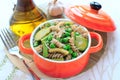 Wholegrain pasta with green vegetables in ceramic pan Royalty Free Stock Photo