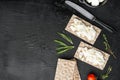 Wholegrain Rye Crispbread with cream cheese, on black dark stone table background, top view flat lay, with copy space for text Royalty Free Stock Photo