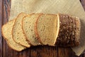 Wholegrain sliced organic bread composed of oats and flax seeds on wooden table. Healthy Diet