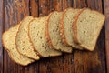 Wholegrain sliced organic bread composed of oats and flax seeds on wooden table. Healthy Diet