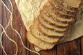 Wholegrain sliced organic bread composed of oats and flax seeds on wooden table, on paper. Healthy Diet