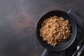 Wholegrain spelt farro in bowl on brown background. Top view