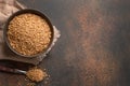 Wholegrain spelt farro in wooden bowl on brown background. Top view. Copy space