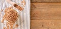 Wholegrain uncooked raw spelt farro in a bowl with napkin on the wooden table