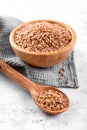 Wholegrain uncooked raw spelt farro in wooden bowl on grey stone table Royalty Free Stock Photo